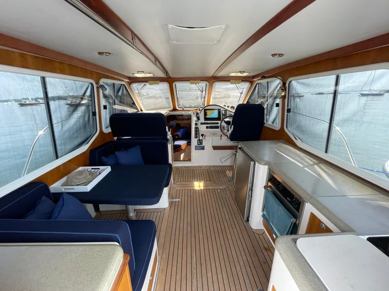 Slide: The Image of Interior of 2007 True North 38 yacht with seating, helm, and kitchenette. - 11
