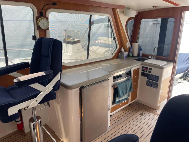 Slide: The Image of Interior of 2007 True North 38 boat with kitchen and seating area. - 13