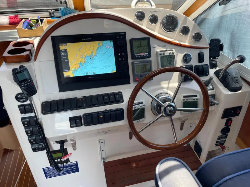 Slide: The Image of Helm of 2007 True North 38 boat with navigation equipment and wooden steering wheel. - 14