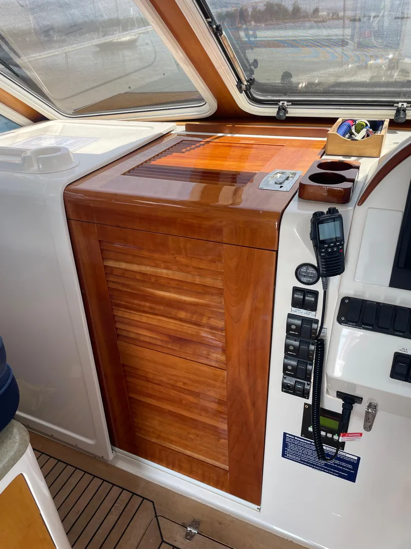 Slide: The Image of Wooden cabinet and control panel inside a 2007 True North 38 boat cockpit. - 16