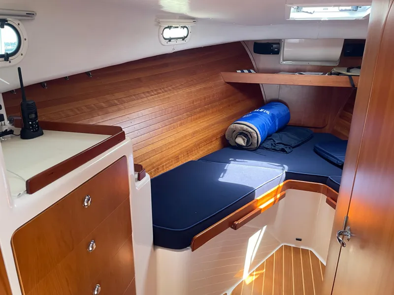 Slide: The Image of Cozy cabin interior of 2007 True North 38 boat with wooden paneling and blue cushions. - 17