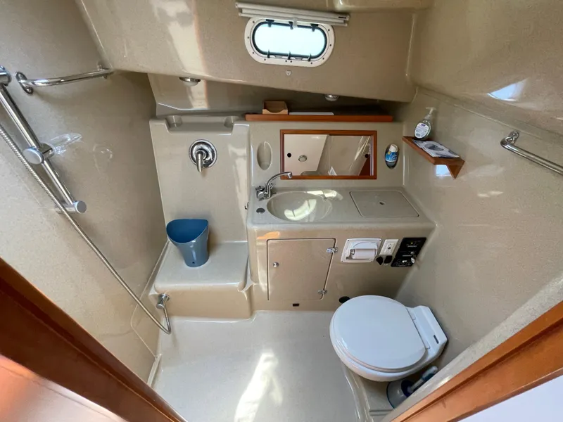 Slide: The Image of Compact bathroom in 2007 True North 38 boat with shower, toilet, and sink. - 19