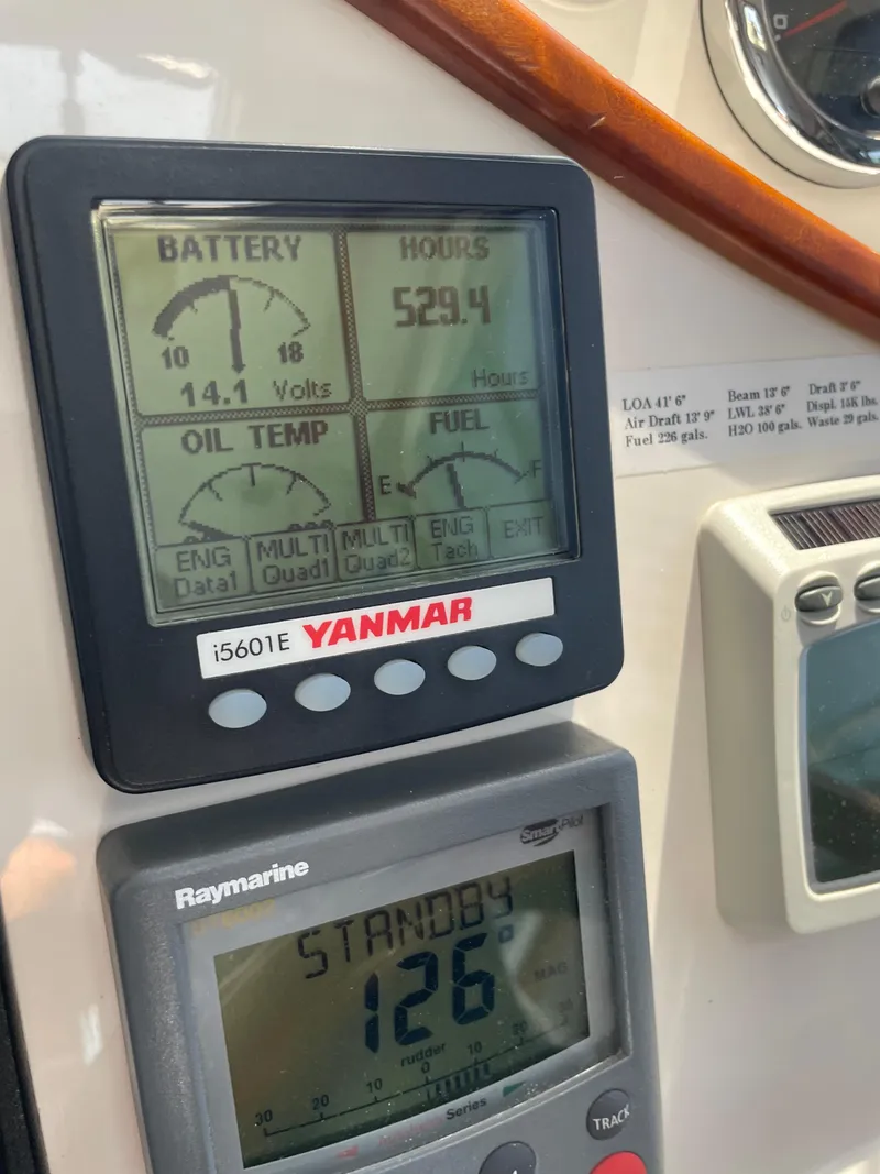 Slide: The Image of Yanmar engine display showing battery voltage, hours, oil temperature, and fuel level on a 2007 True North 38. - 21