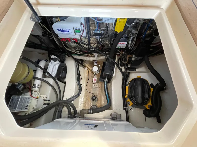 Slide: The Image of Engine compartment of a 2007 True North 38 boat, showing various mechanical components and wiring. - 24