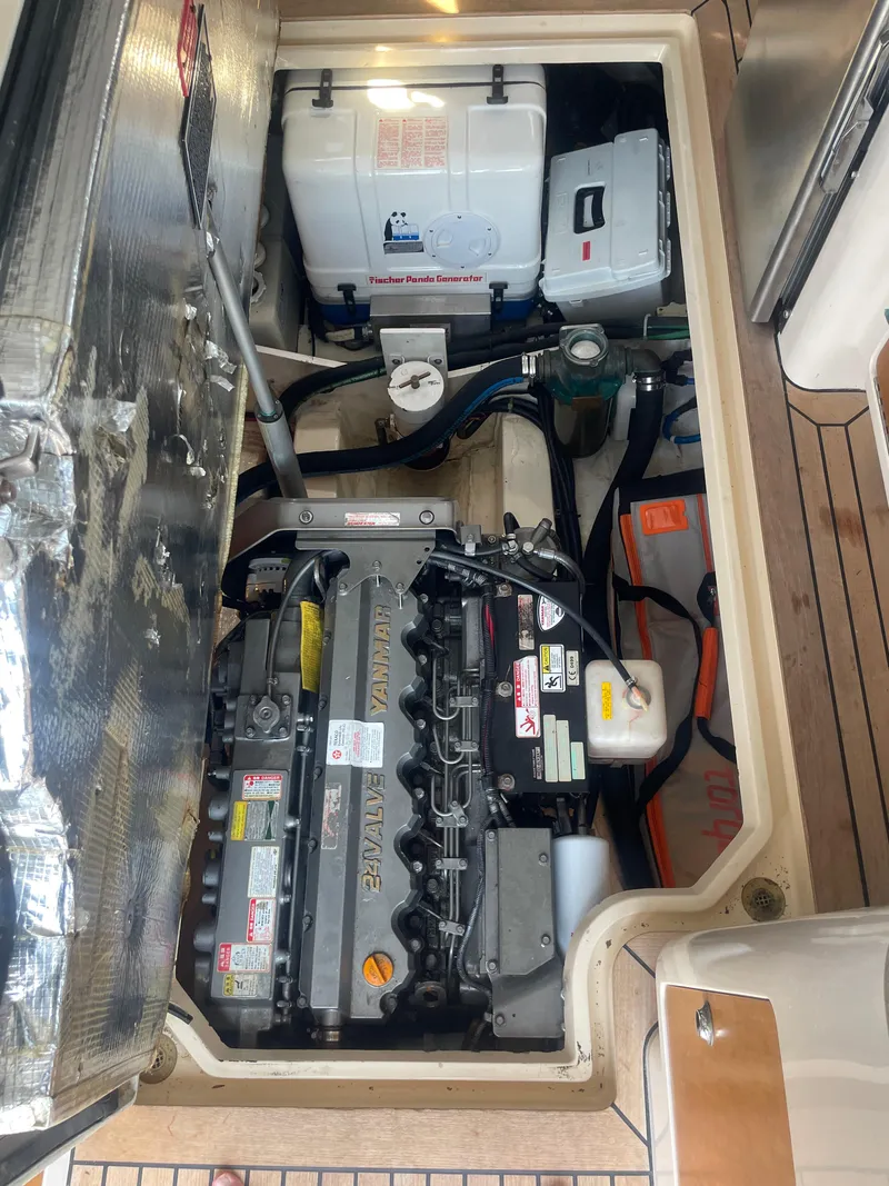 Slide: The Image of Engine compartment of a 2007 True North 38 boat, featuring a Yanmar engine and Panda generator. - 25