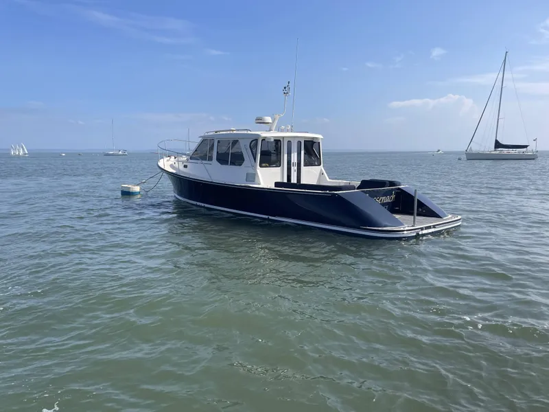 Slide: The Image of 2007 True North 38 boat moored on calm water under a clear blue sky. - 3