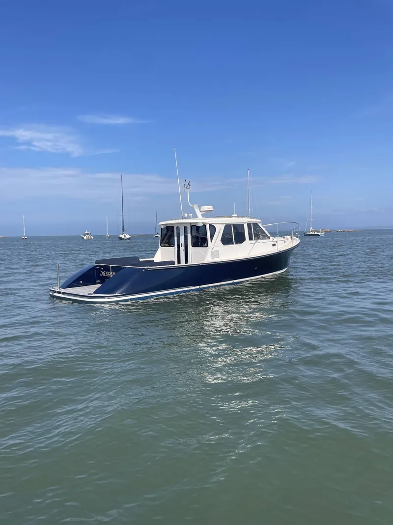 Slide: The Image of 2007 True North 38 boat on calm water under clear blue sky. - 4