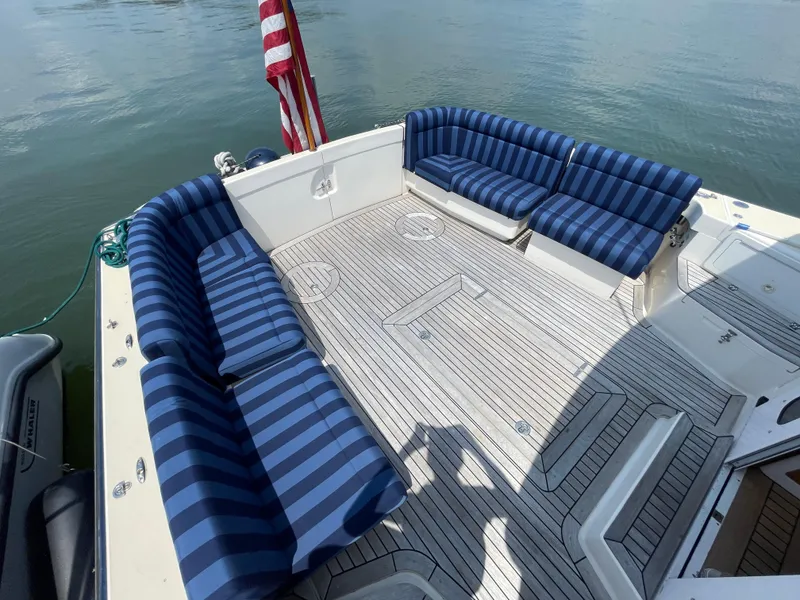 Slide: The Image of 2007 True North 38 boat deck with striped blue seating and American flag. - 5