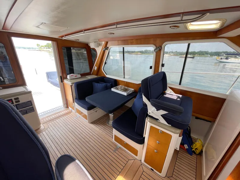 Slide: The Image of Interior of a 2007 True North 38 boat with blue seating and wooden accents. - 8