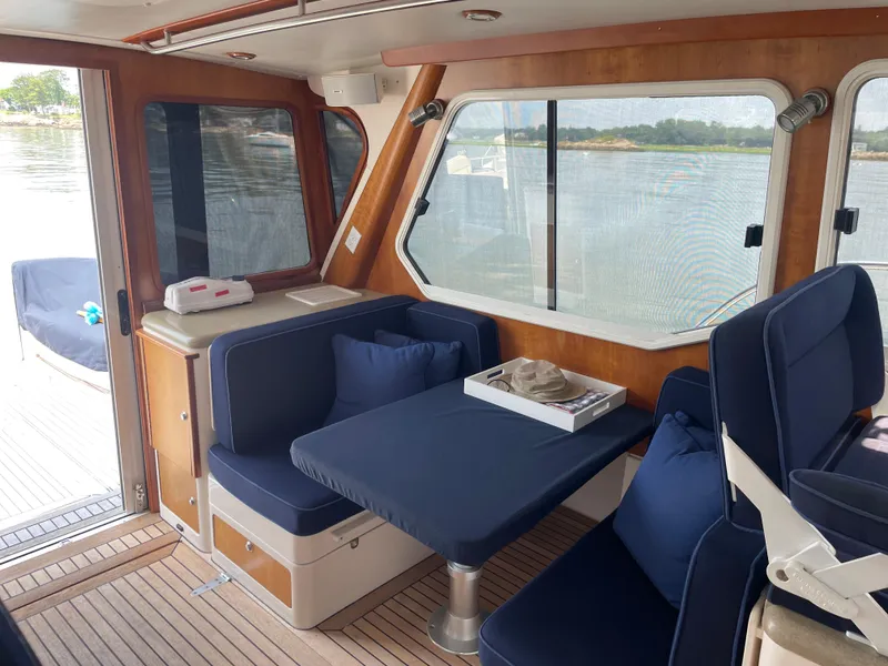 Slide: The Image of Interior of 2007 True North 38 boat with blue seating and wooden accents. - 9