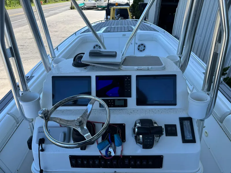 Slide: The Image of 1998 Wellcraft Scarab Sport 302 boat dashboard with steering wheel and navigation screens. - 10