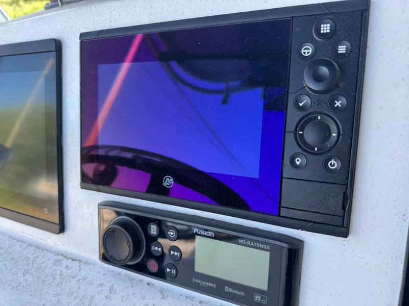 Slide: The Image of Control panel of a 1998 Wellcraft Scarab Sport 302 boat with navigation and audio systems. - 11