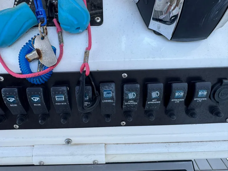 Slide: The Image of Control panel of a 1998 Wellcraft Scarab Sport 302 boat with labeled switches. - 16