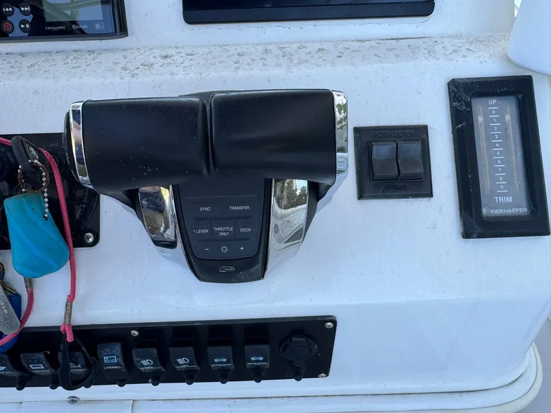 Slide: The Image of Control panel of a 1998 Wellcraft Scarab Sport 302 boat, featuring throttle and trim controls. - 17