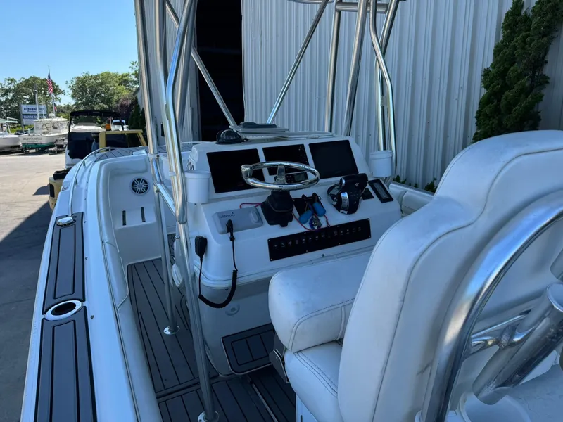 Slide: The Image of 1998 Wellcraft Scarab Sport 302 boat interior with steering console and seating. - 18
