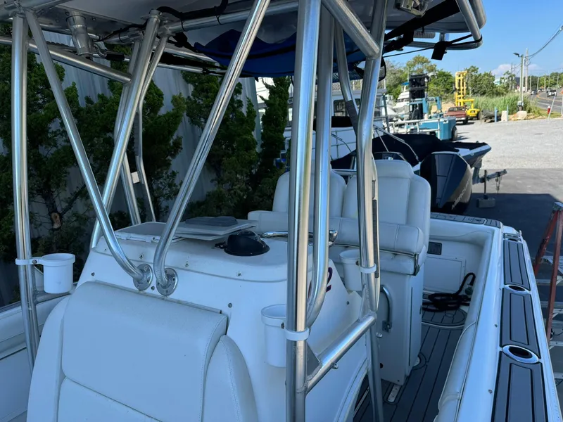 Slide: The Image of 1998 Wellcraft Scarab Sport 302 boat interior with white seating and metal framework. - 21