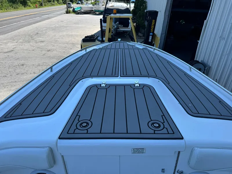 Slide: The Image of 1998 Wellcraft Scarab Sport 302 boat deck with sleek, modern design in a marina setting. - 23