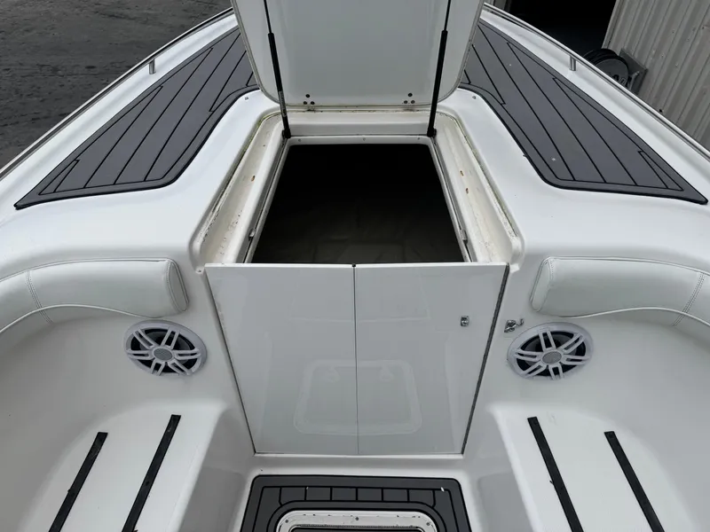 Slide: The Image of 1998 Wellcraft Scarab Sport 302 boat interior with open storage compartment and speakers. - 24