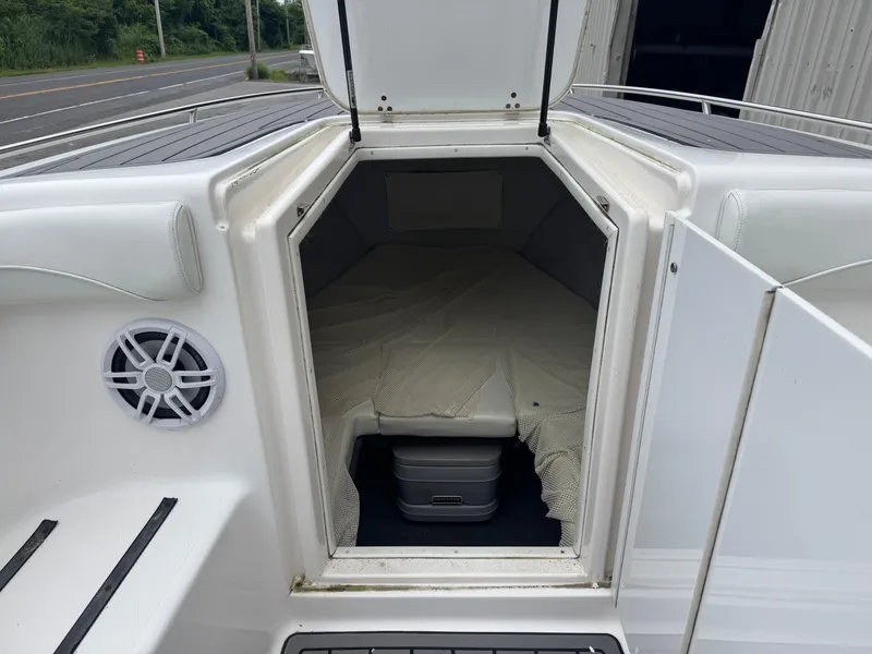 Slide: The Image of 1998 Wellcraft Scarab Sport 302 cabin interior with open hatch and speaker. - 25