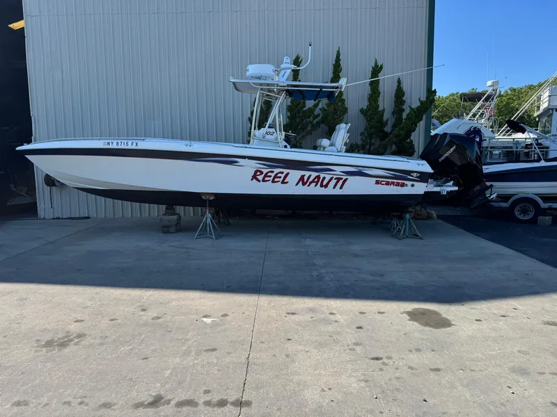 Slide: The Image of 1998 Wellcraft Scarab Sport 302 boat named "Reel Nauti" on dry dock. - 31