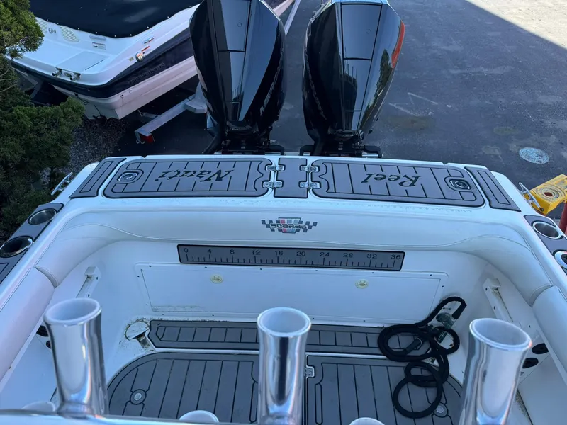 Slide: The Image of 1998 Wellcraft Scarab Sport 302 boat with dual engines and fishing rod holders. - 5