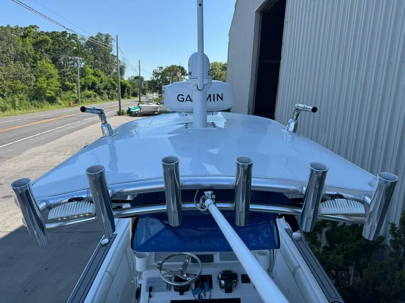 Slide: The Image of 1998 Wellcraft Scarab Sport 302 boat with Garmin equipment, docked near a road. - 8