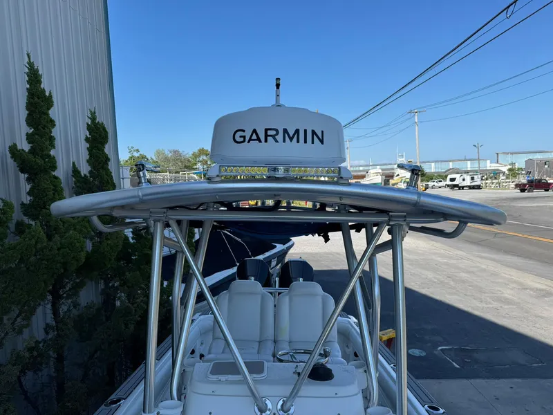Slide: The Image of 1998 Wellcraft Scarab Sport 302 boat with Garmin radar, docked near a marina. - 9