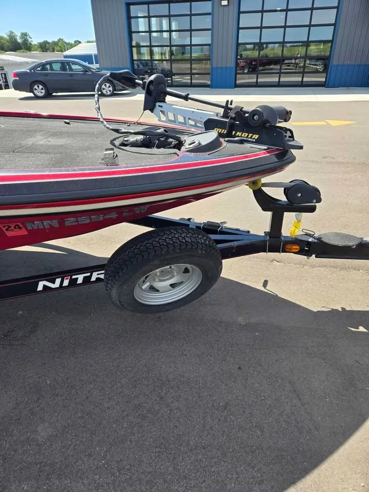 Slide: The Image of 2011 Nitro Z-7 boat with trailer, parked outside a building. - 3