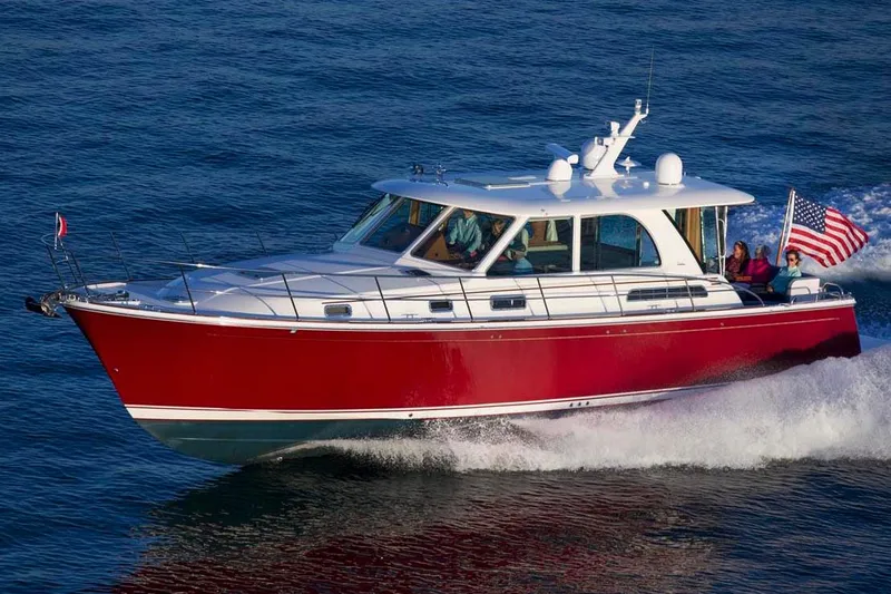 The Image of 2026 Sabre 45 Salon Express cruising near rocky cliffs in scenic waters. - 0