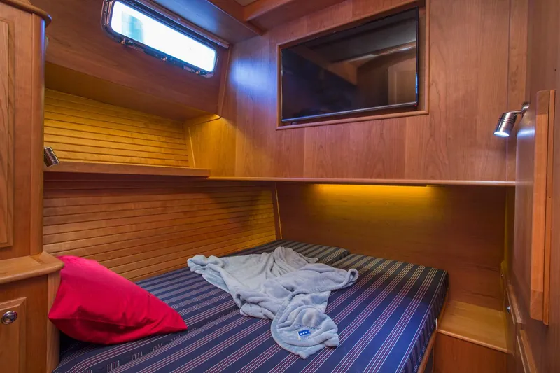 Slide: The Image of 2026 Sabre 45 Salon Express cabin with wooden interior and cozy twin beds. - 12