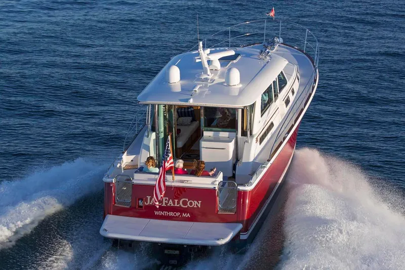 Slide: The Image of 2026 Sabre 45 Salon Express yacht docked near industrial waterfront buildings. - 4