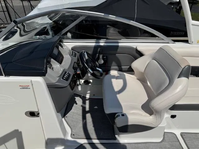 Slide: The Image of 2017 Chaparral 250 Suncoast boat interior with steering wheel and seating area. - 10