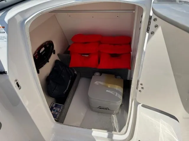 Slide: The Image of 2017 Chaparral 250 Suncoast storage area with life jackets and portable toilet. - 14