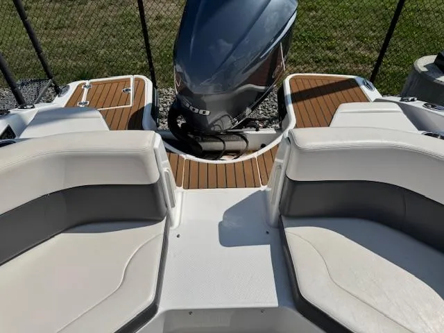 Slide: The Image of 2017 Chaparral 250 Suncoast boat interior with seating and outboard motor. - 23