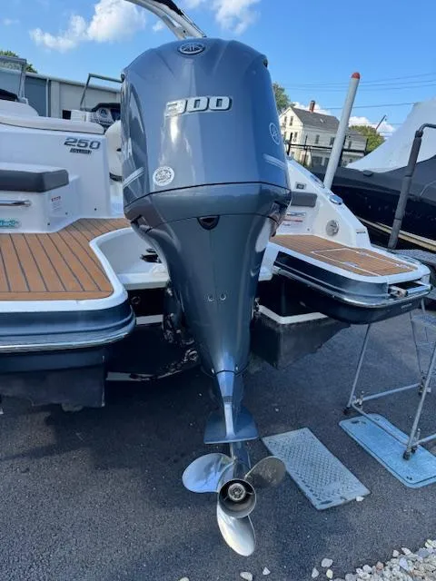 Slide: The Image of 2017 Chaparral 250 Suncoast boat with Yamaha 300 outboard motor, docked on a sunny day. - 27