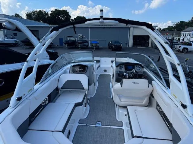 Slide: The Image of 2017 Chaparral 250 Suncoast boat interior with seating and dashboard, parked outdoors. - 3