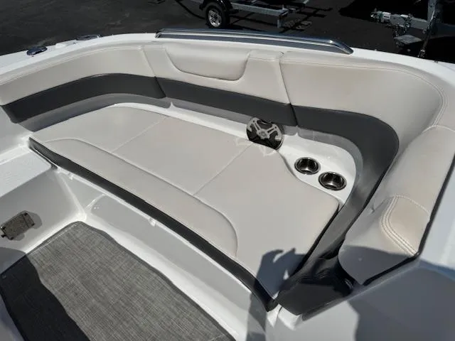 Slide: The Image of 2017 Chaparral 250 Suncoast boat interior with cushioned seating and cup holders. - 6