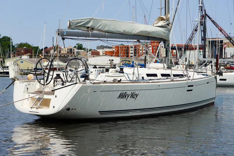Slide: The Image of Sailing yacht Dufour 40E Performance 2011 docked in a marina, named "Milky Way". - 14