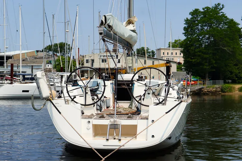 Slide: The Image of Sailboat Dufour 40E Performance 2011 docked at marina, rear view with dual steering wheels. - 15