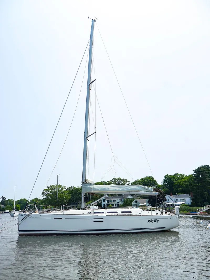 Slide: The Image of Sailing yacht Dufour 40E Performance 2011 on calm water, surrounded by greenery. - 16