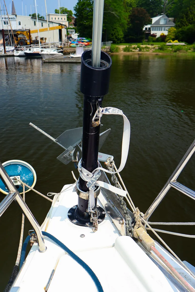 Slide: The Image of Bow of 2011 Dufour 40E Performance sailboat with anchor and rigging, docked near marina. - 17