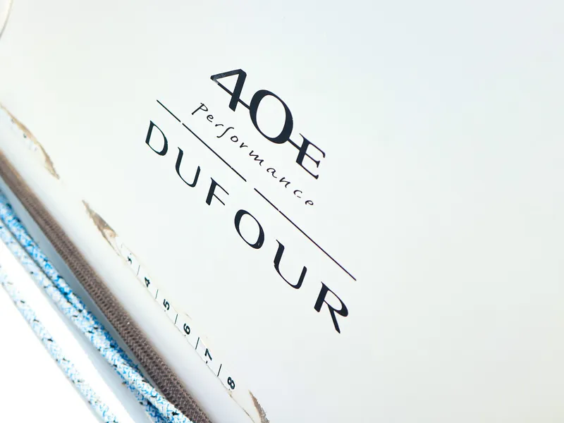 Slide: The Image of Dufour 40E Performance 2011 yacht logo on white surface with ropes. - 28
