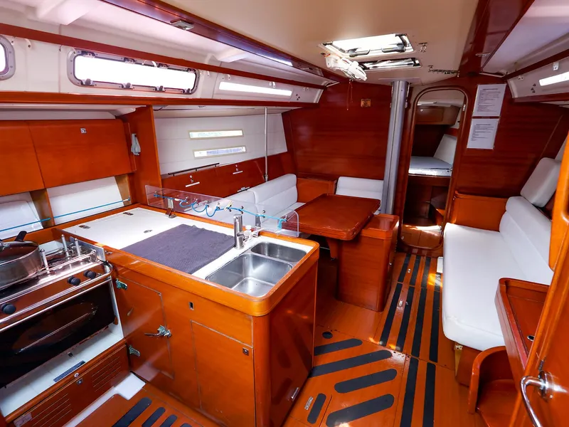 Slide: The Image of Interior of 2011 Dufour 40E Performance yacht with kitchen and seating area. - 29