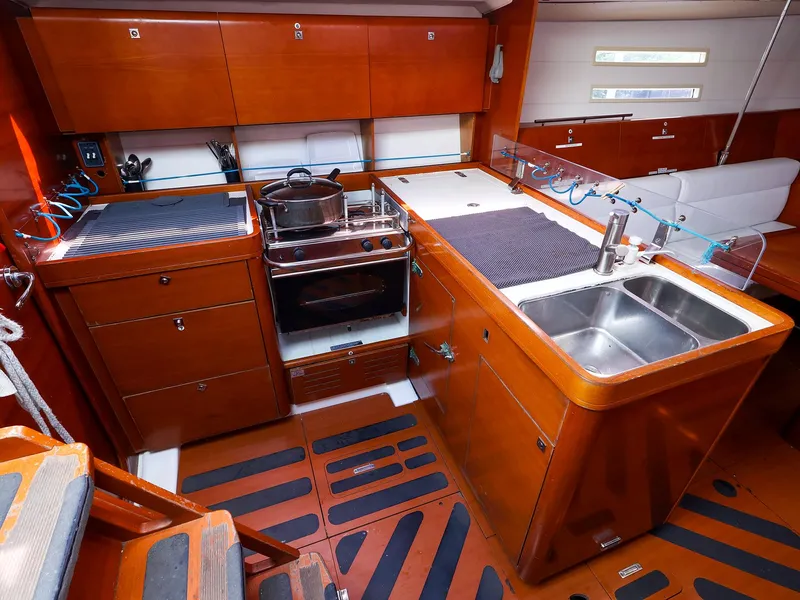 Slide: The Image of Luxurious 2011 Dufour 40E Performance yacht kitchen with wood cabinetry and modern appliances. - 31