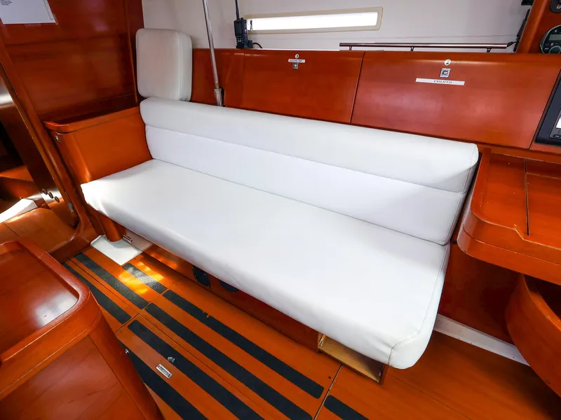 Slide: The Image of Interior of 2011 Dufour 40E Performance yacht with white seating and wooden finish. - 33