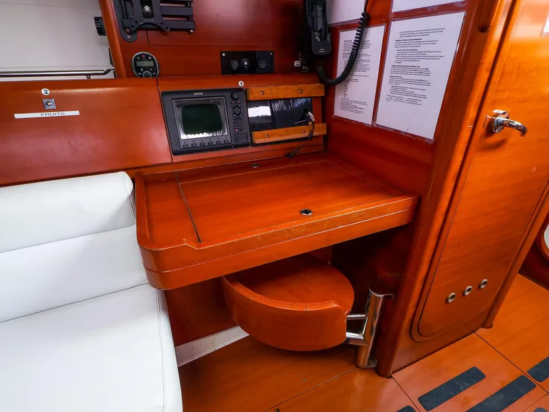 Slide: The Image of Navigation station on 2011 Dufour 40E Performance yacht with wooden desk and instruments. - 34