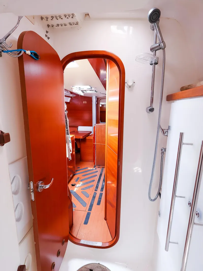 Slide: The Image of Interior of 2011 Dufour 40E Performance yacht, featuring a wooden door and shower area. - 37