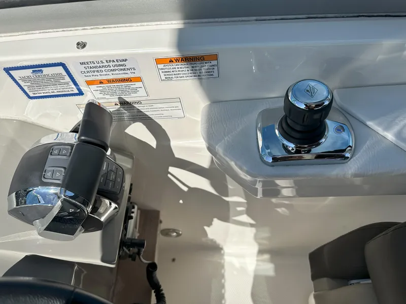 Slide: The Image of Control panel of a 2015 Sea Ray 350 Sundancer boat with joystick and throttle. - 11