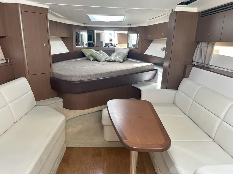 Slide: The Image of Interior of 2015 Sea Ray 350 Sundancer yacht with modern seating and cozy bed. - 17