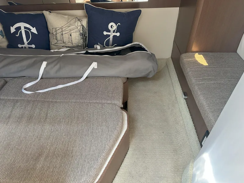 Slide: The Image of Interior cabin of 2015 Sea Ray 350 Sundancer with nautical-themed cushions. - 18